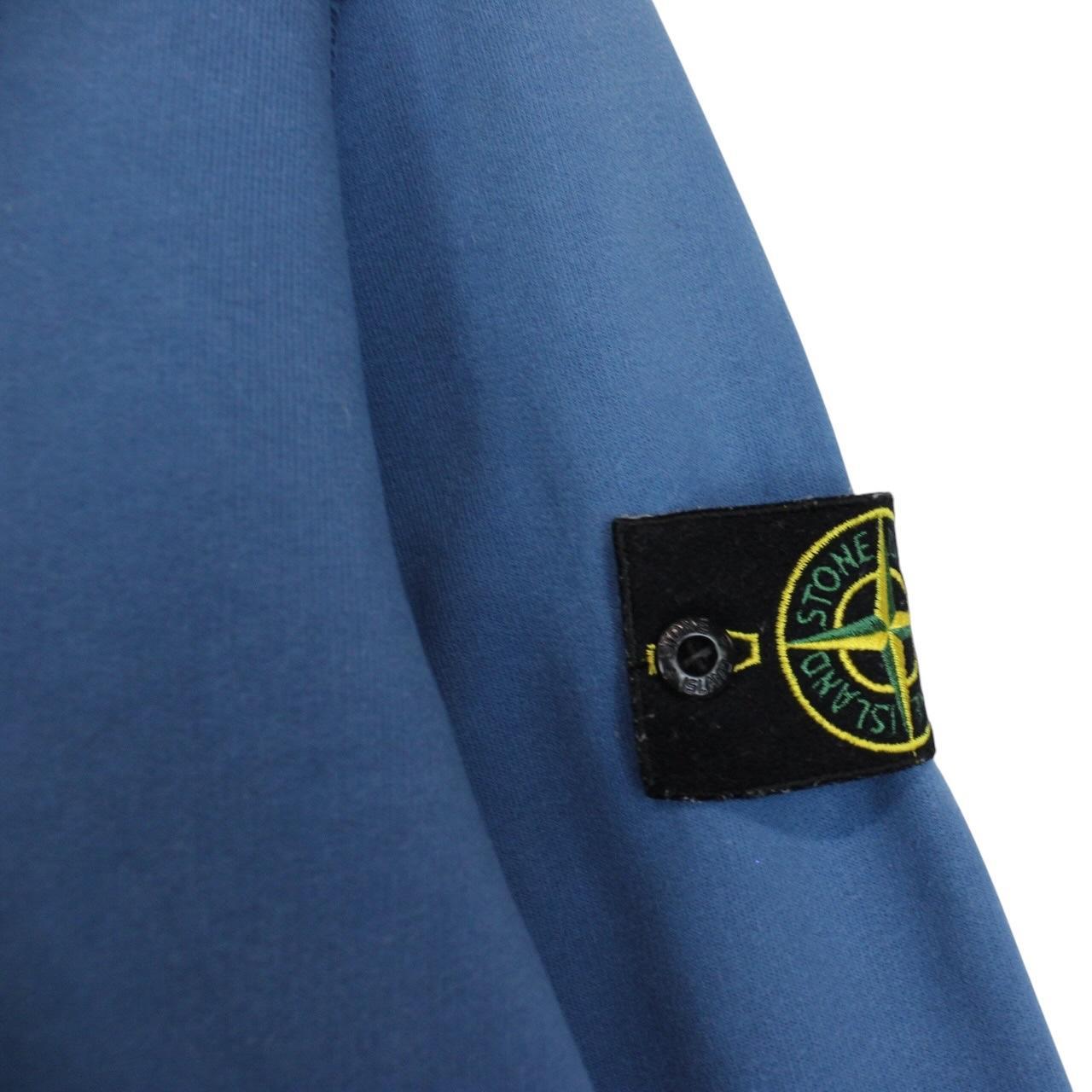 Stone Island blue cotton sweatshirt with logo patch and faded details.