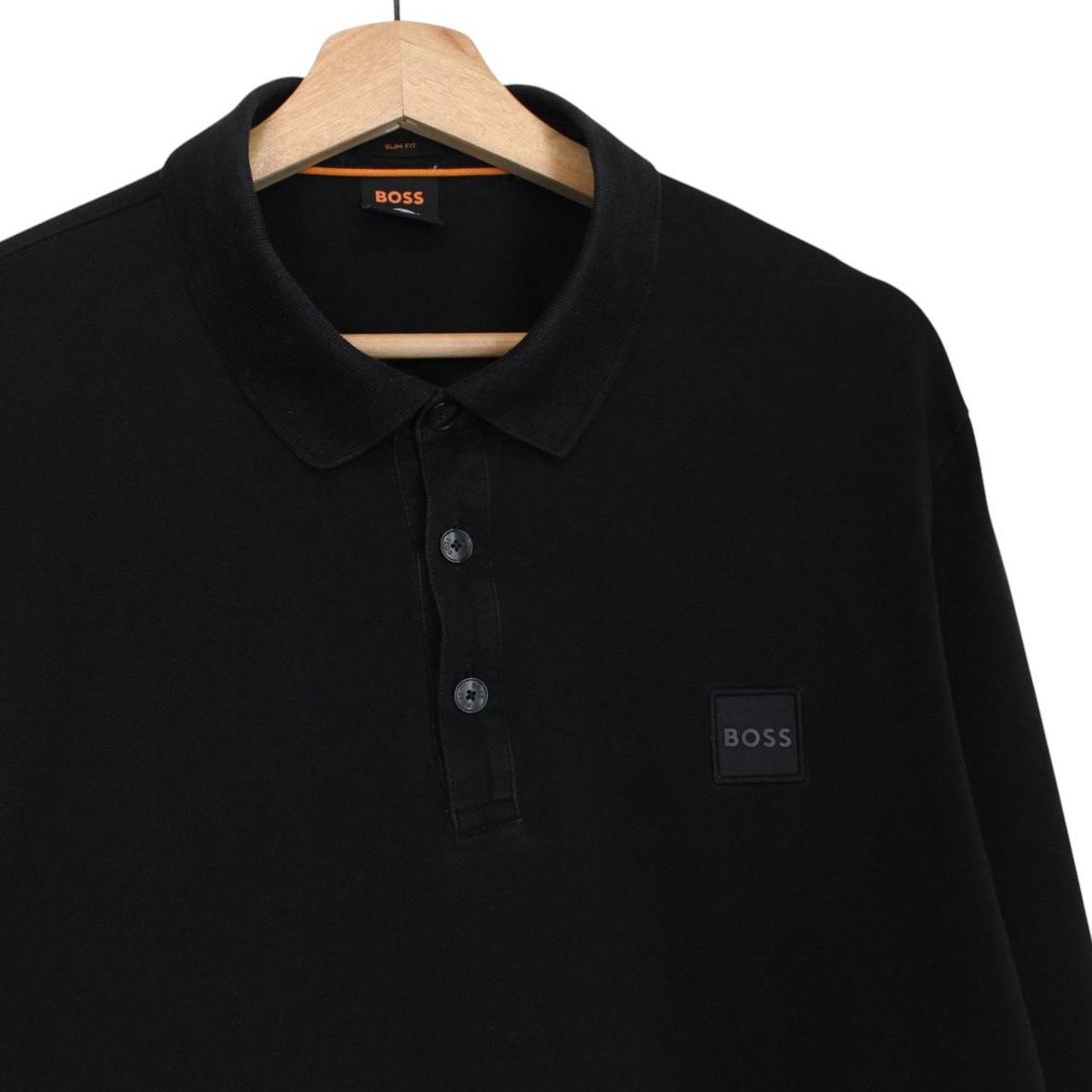 Hugo Boss black long sleeve polo shirt, slim fit, cotton material, subtle wear marks.