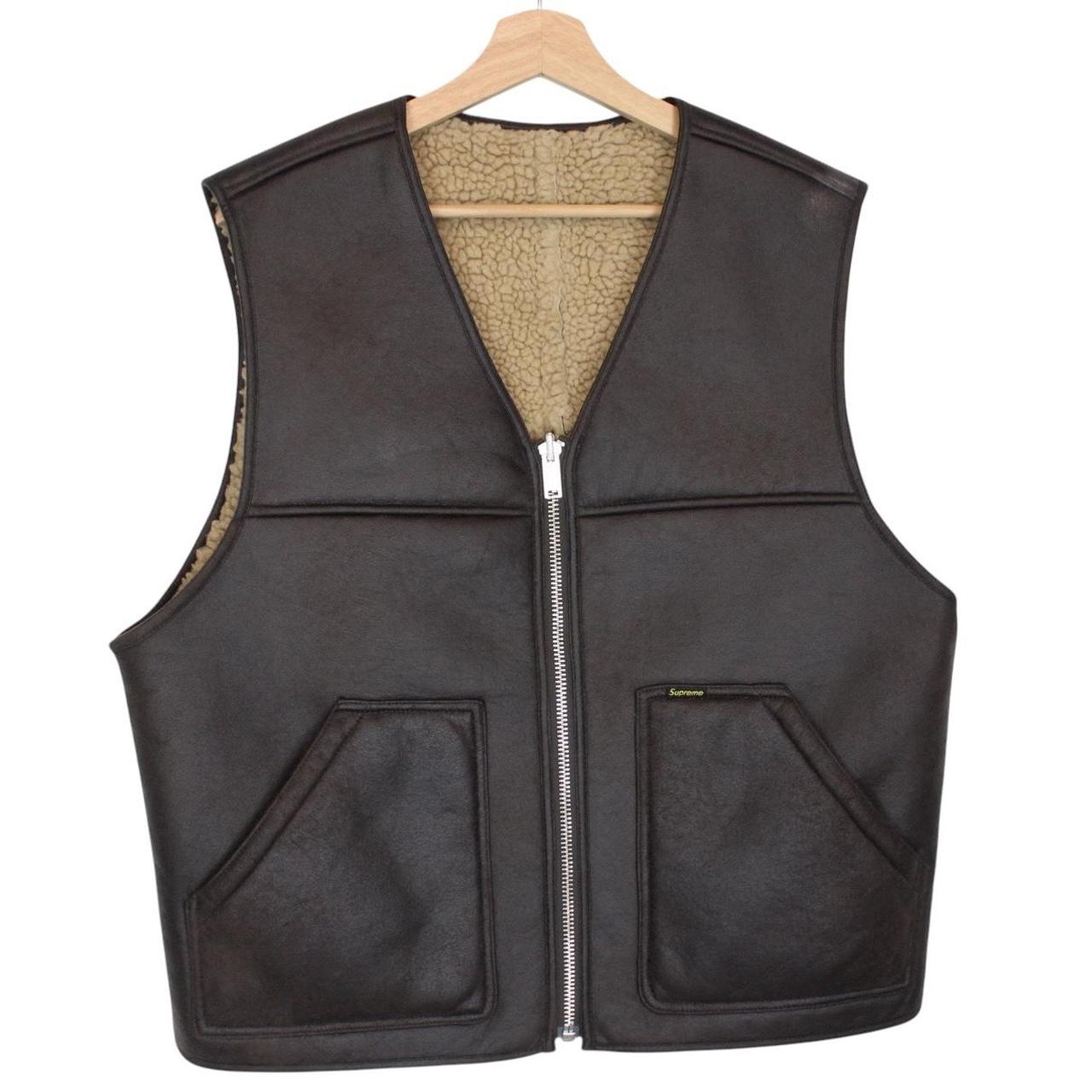 Supreme brown reversible faux shearling work vest with logo patch and textured fabric.