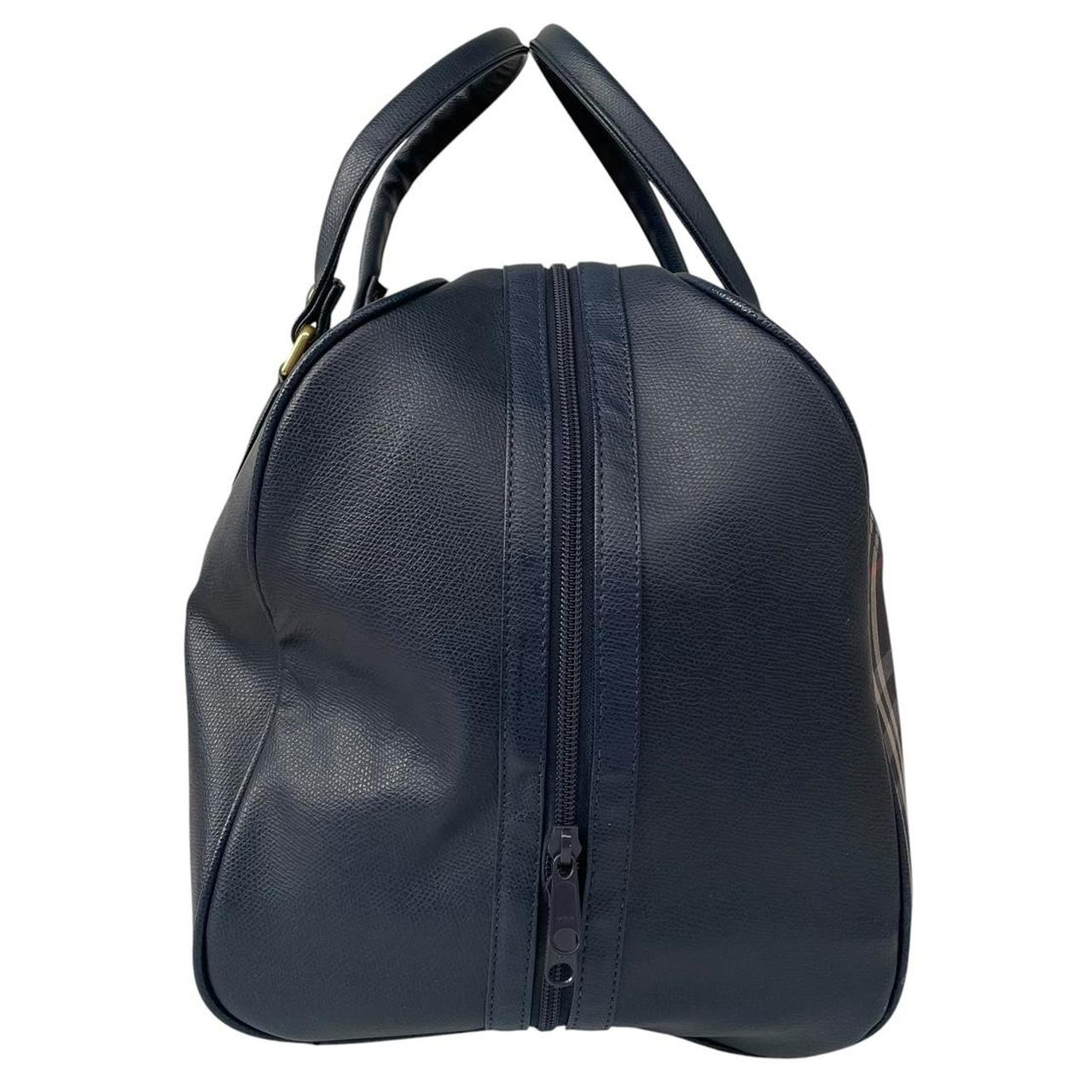 Burberry navy blue duffel bag featuring iconic Nova Check pattern and leather accents.