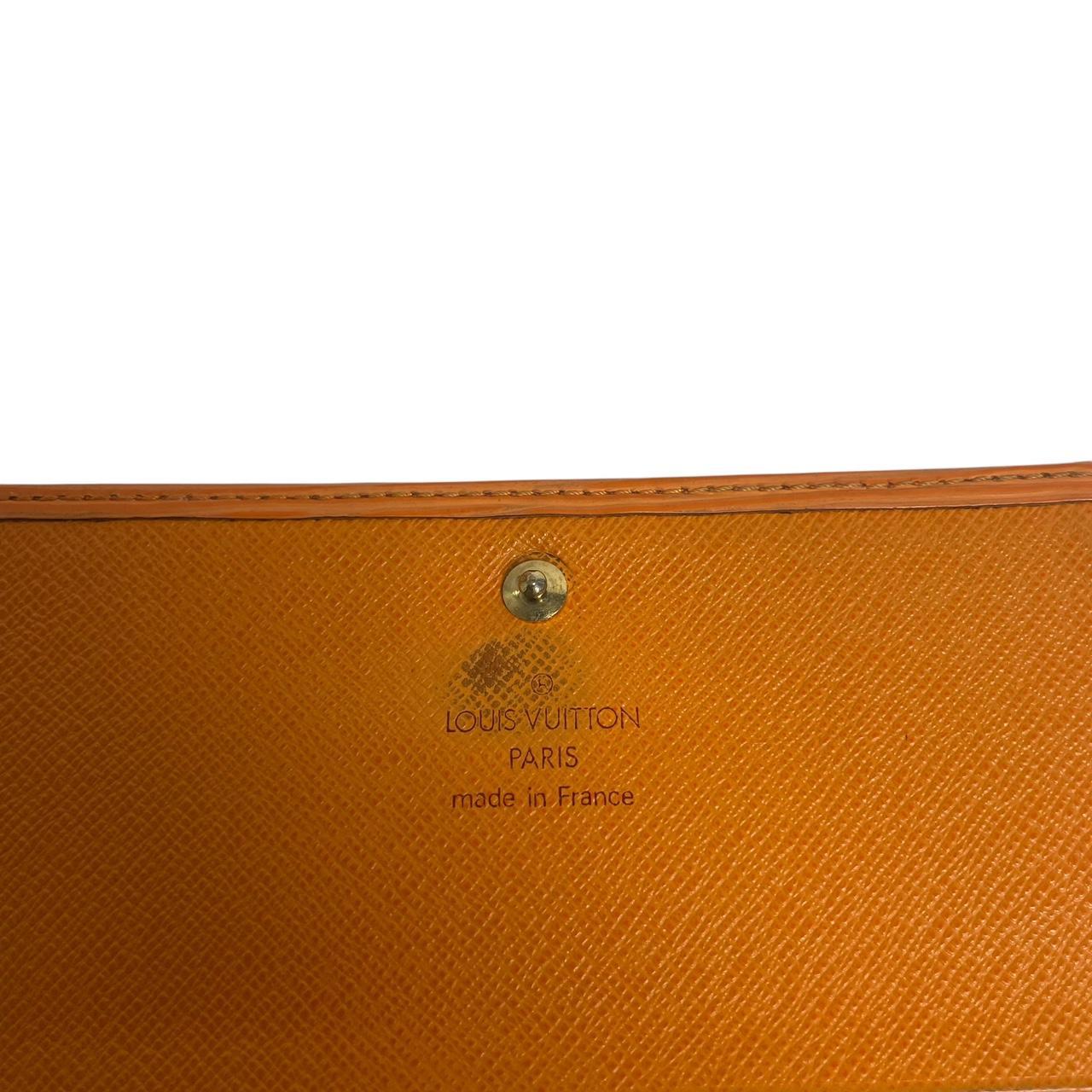 Louis Vuitton orange leather wallet with Epi texture and embossed logo detail.