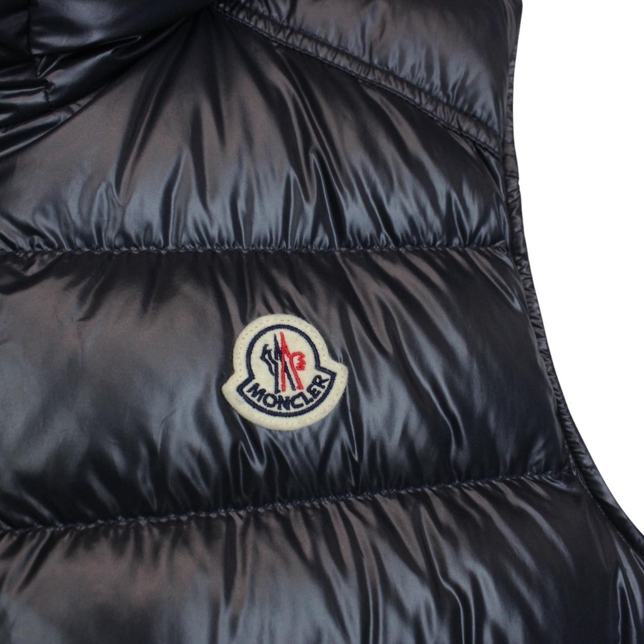 Moncler navy blue hooded nylon down gilet with logo and quilted texture.