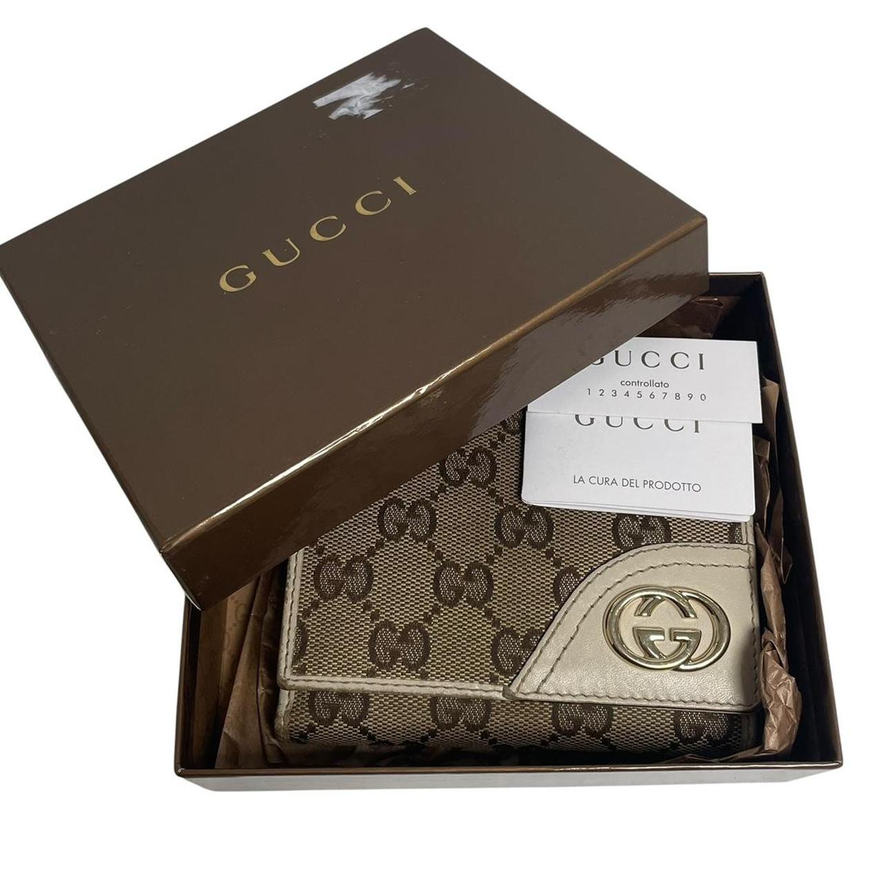 Gucci brown bifold wallet with Supreme monogram pattern and leather accents.