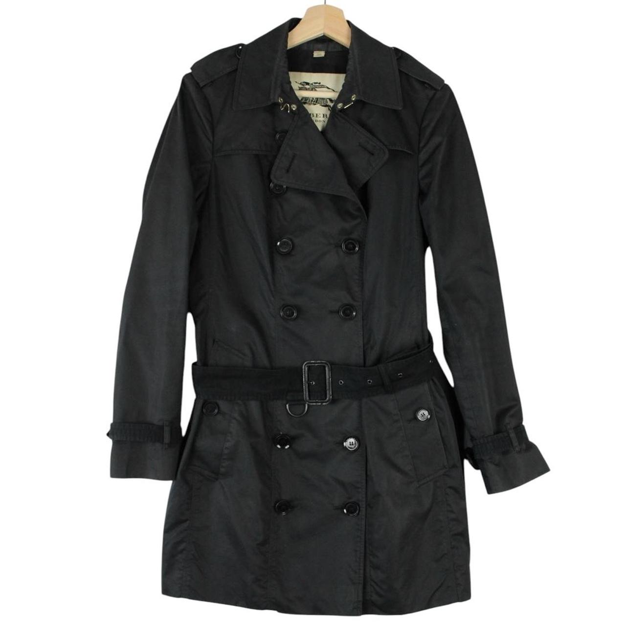 Burberry black double breasted belted trench coat with logo detailing and classic design.