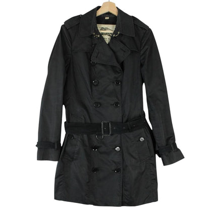 Burberry black double breasted belted trench coat with logo detailing and classic design.