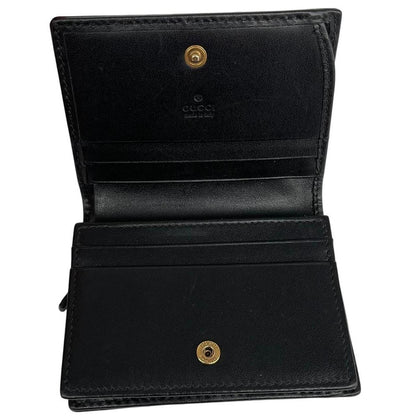 Gucci black calfskin card case wallet with matelasse pattern and GG logo.