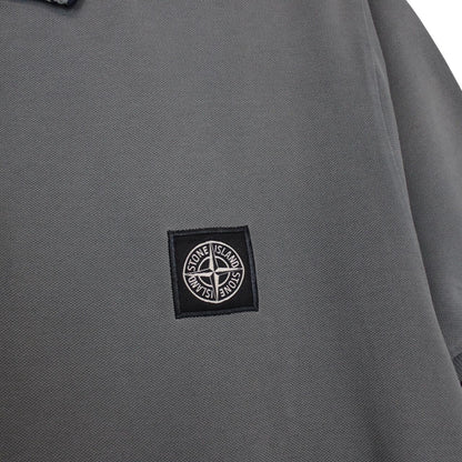 Stone Island grey polo shirt with embroidered compass logo and cotton material.