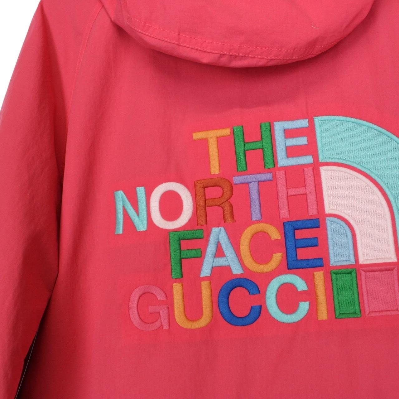 Gucci pink windbreaker jacket with North Face logo and full zip design.