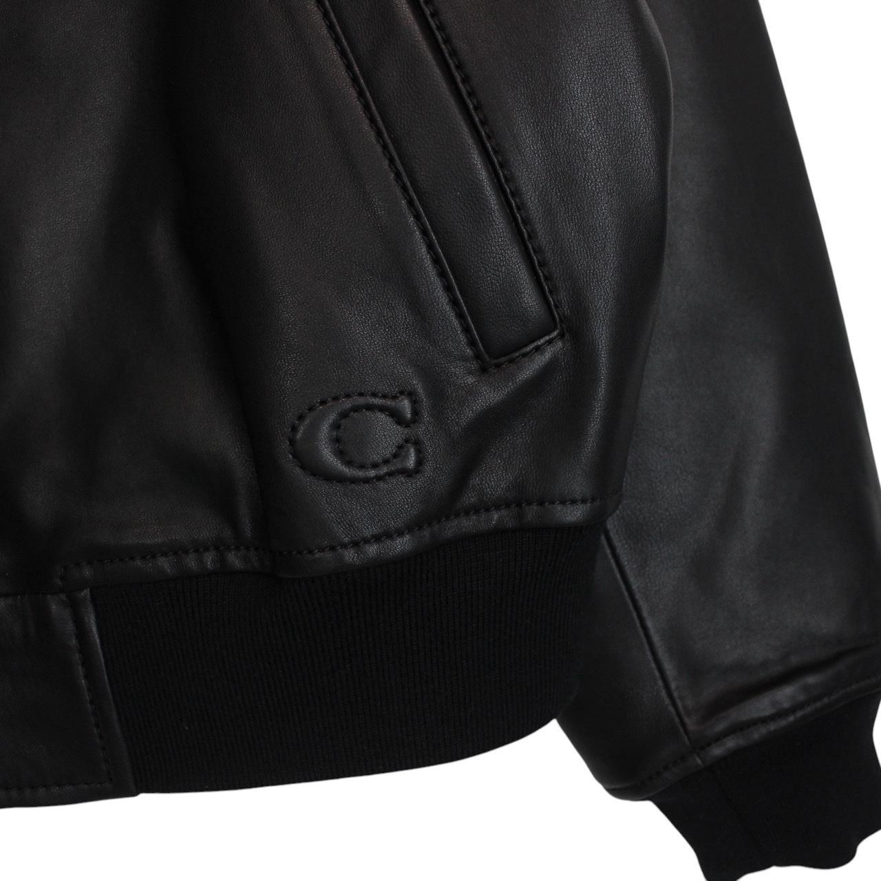 Coach black lamb leather bomber jacket with full zip and brand logo.