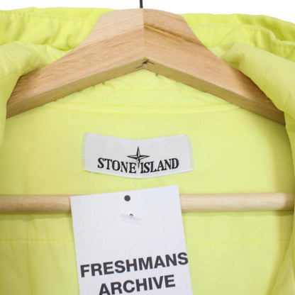 Stone Island yellow jacket with crinkle texture and logo badge on sleeve.