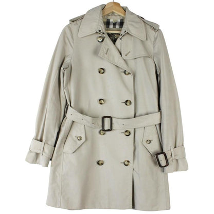 Burberry beige trench coat featuring Nova Check pattern and double-breasted design with belt.