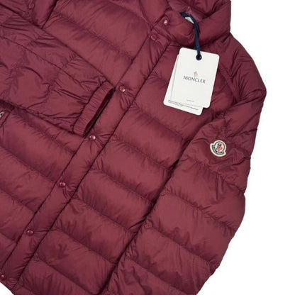 Moncler burgundy quilted down jacket with logo patch and shell material.