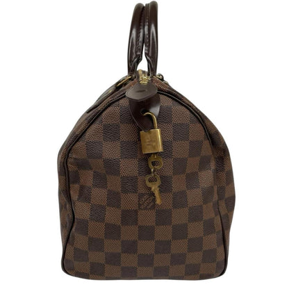 Louis Vuitton brown Damier Ebene canvas handbag with gold hardware and padlock detail.