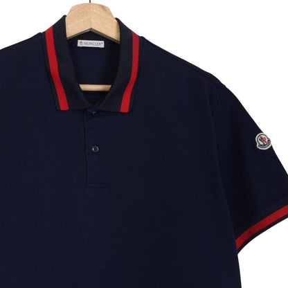 Moncler navy blue short sleeve polo shirt with embroidered logo and cotton material.