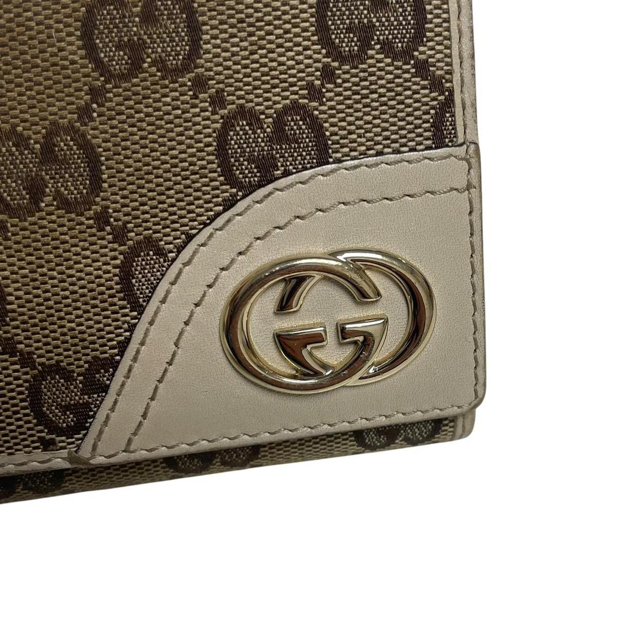 Gucci brown bifold wallet with Supreme monogram pattern and leather accents.