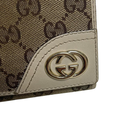 Gucci brown bifold wallet with Supreme monogram pattern and leather accents.