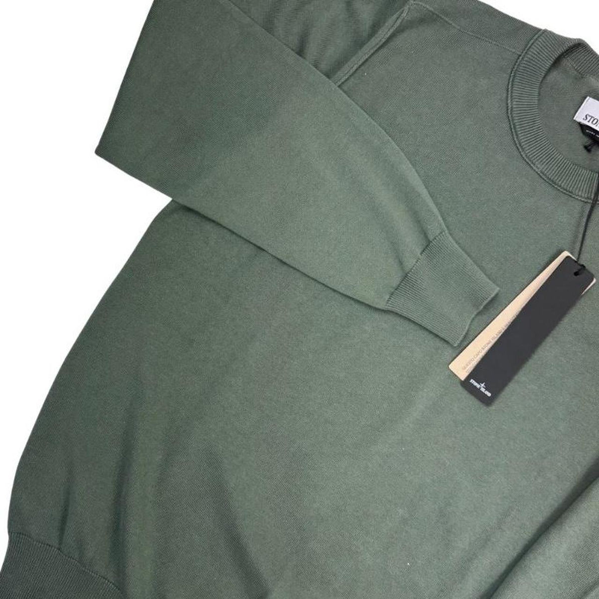 Stone Island green knit jumper made from organic cotton with logo patch detail.