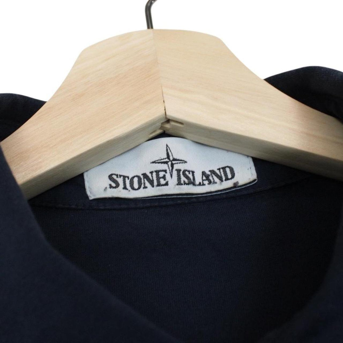 Stone Island navy blue long sleeve polo shirt with iconic compass logo on chest.