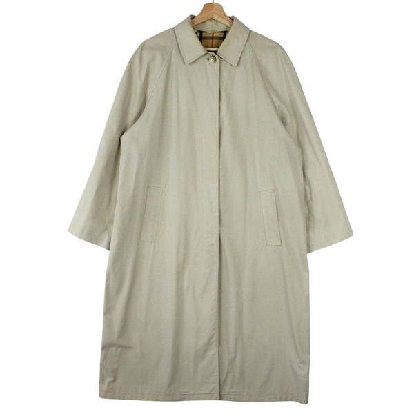 Burberry beige trench coat featuring iconic Nova Check pattern and single breasted design.