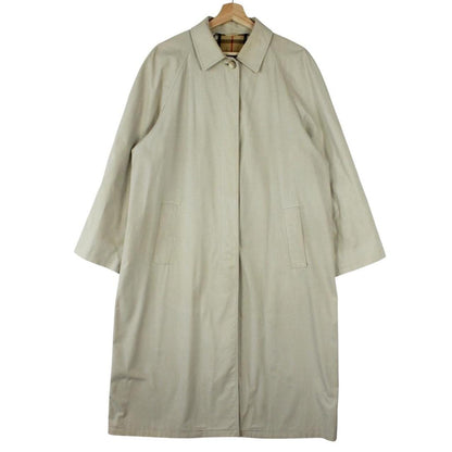 Burberry beige trench coat featuring iconic Nova Check pattern and single breasted design.