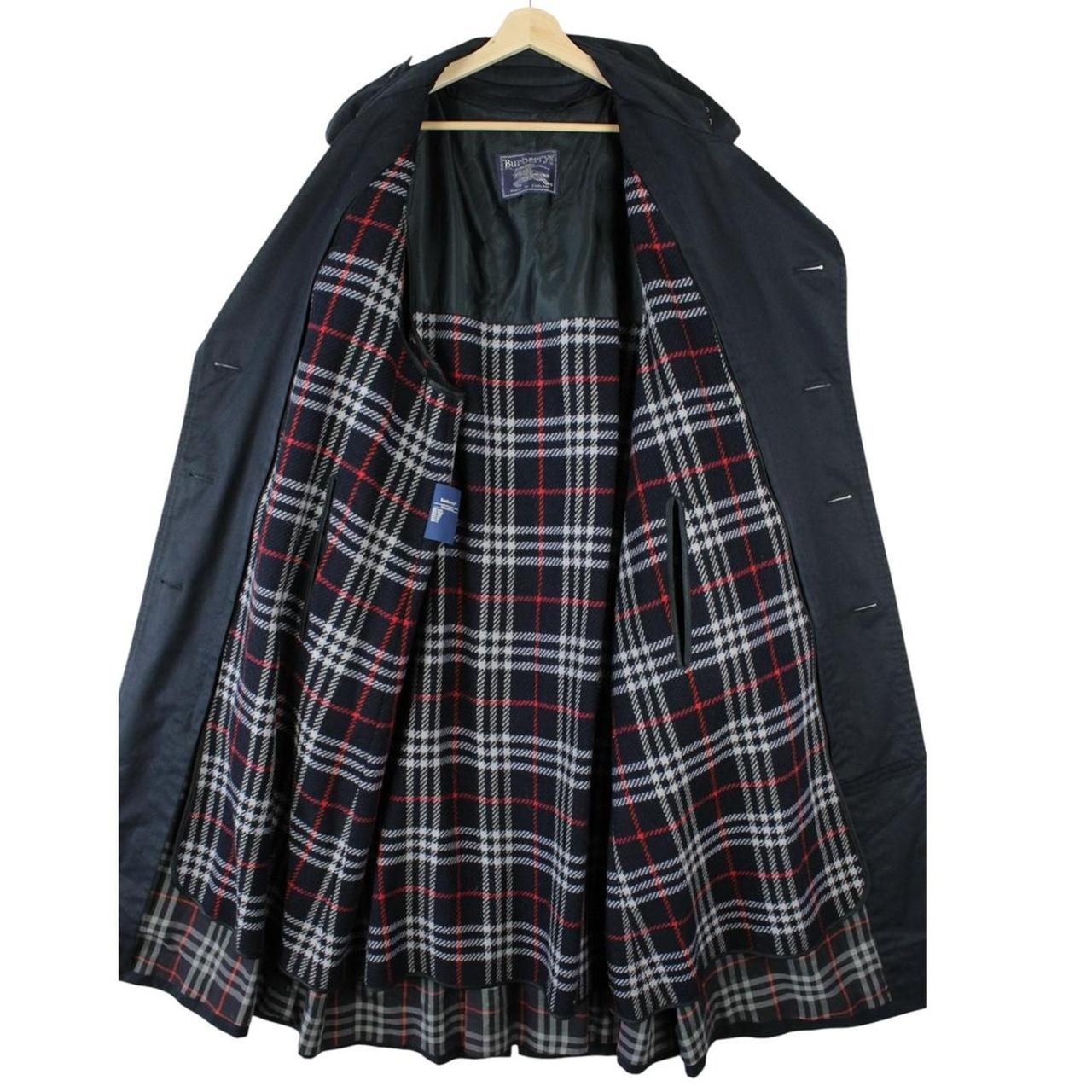 Burberry navy blue belted double breasted trench coat with iconic check lining.