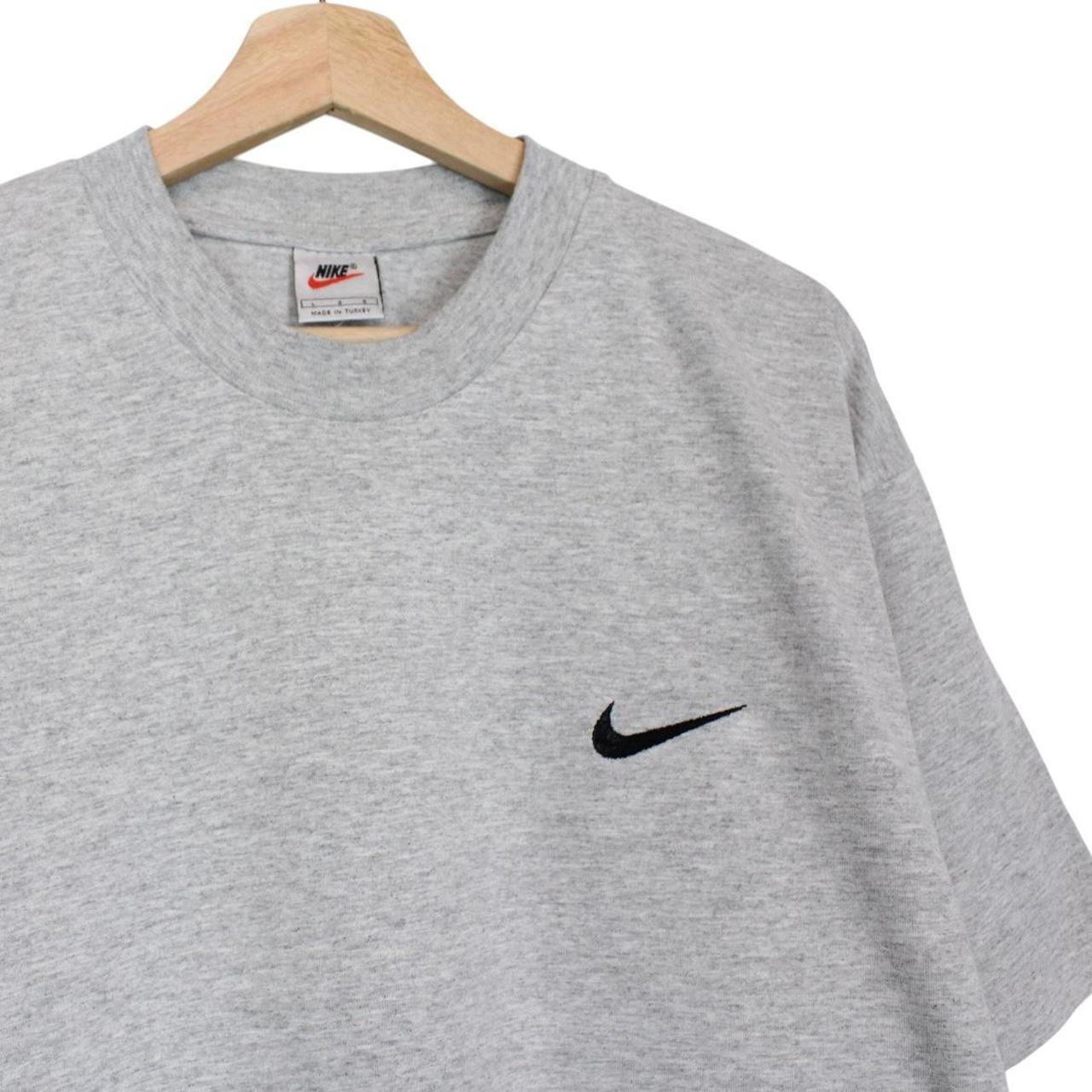 Nike grey short sleeve cotton t-shirt with pocket and vintage logo detail.