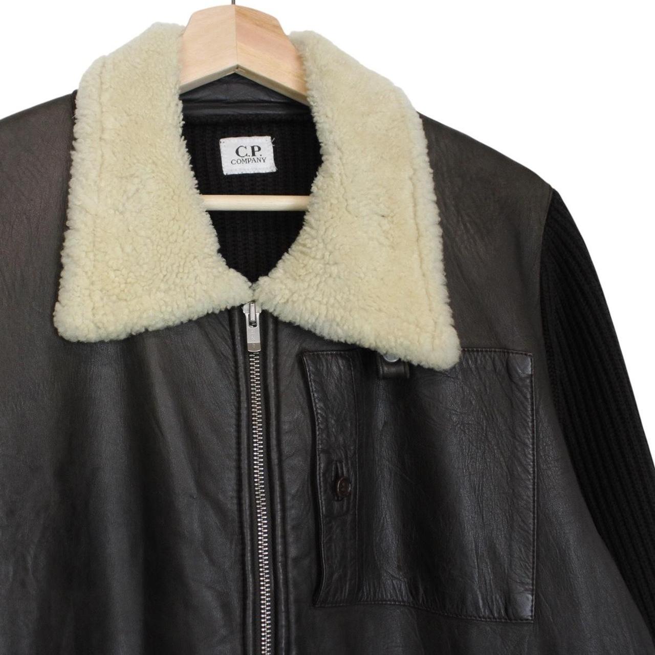 CP Company brown leather and wool shearling jacket with vintage design and logo details.