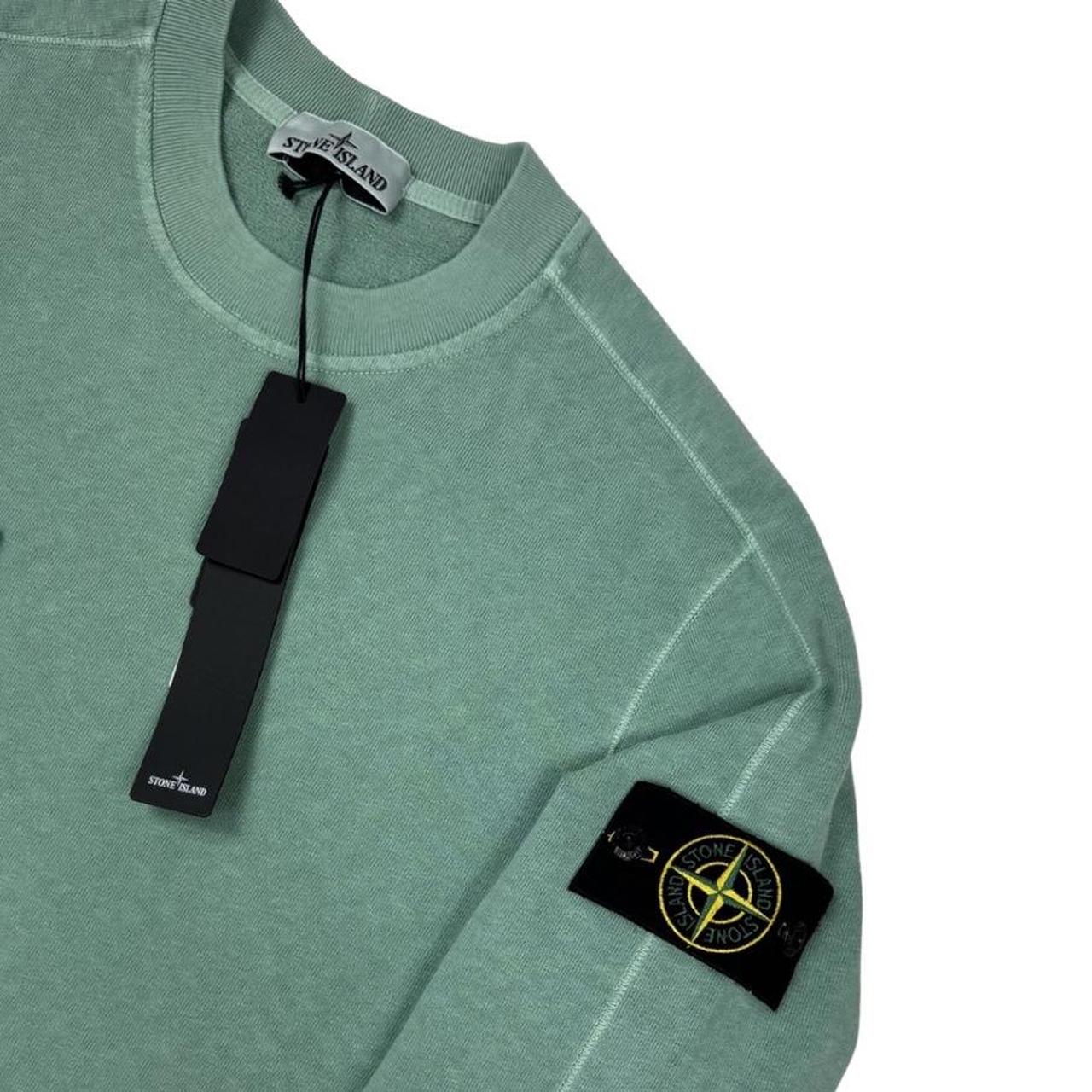 Stone Island green sweatshirt with logo patch and garment dyed cotton material.