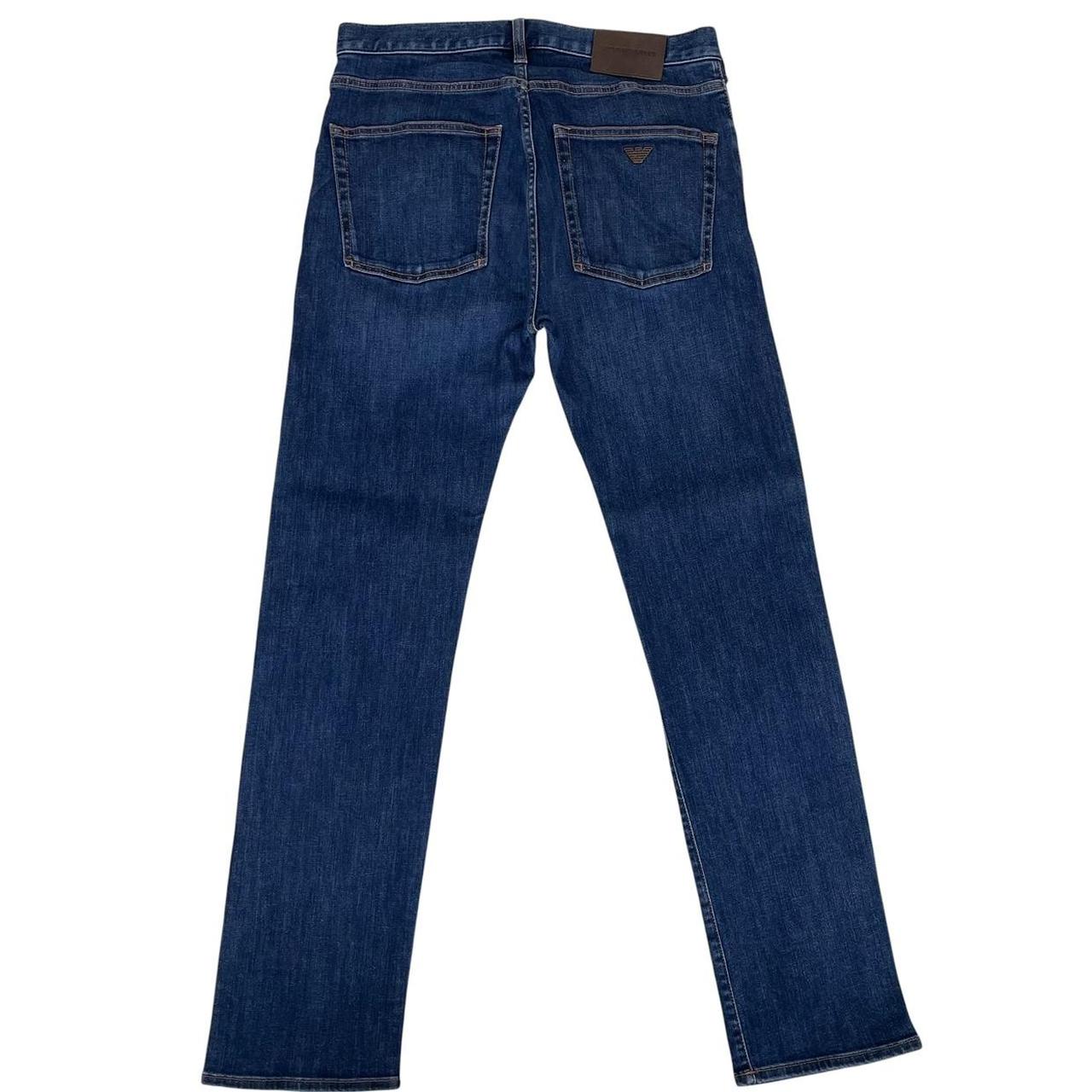 Emporio Armani navy blue slim fit denim jeans with logo patch and classic five-pocket design.
