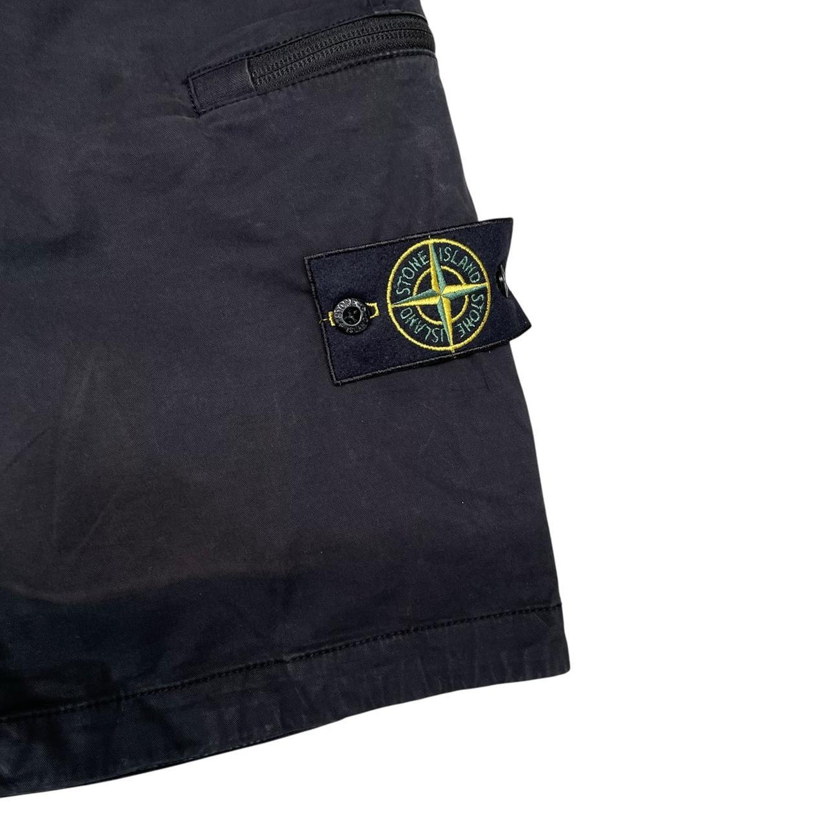 Stone Island navy blue cargo shorts with logo patch and faded cotton material.