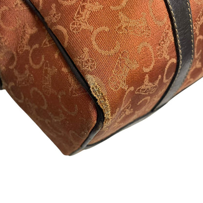 CELINE orange duffel bag with Macadam canvas and leather, visible wear and discolouration.