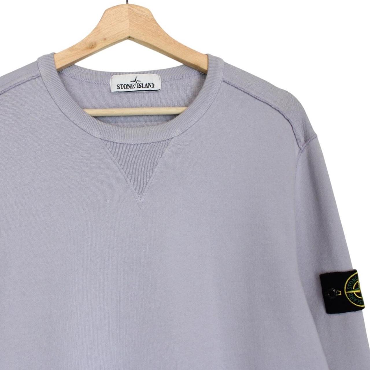 Stone Island lilac purple sweatshirt with compass logo patch and cotton material.