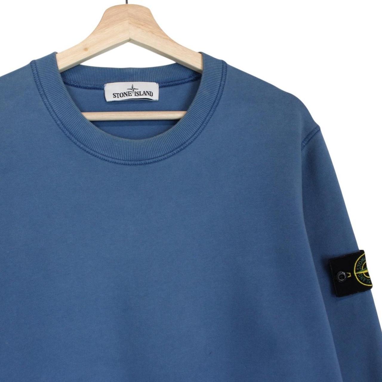 Stone Island blue cotton sweatshirt with iconic compass logo and ribbed cuffs.