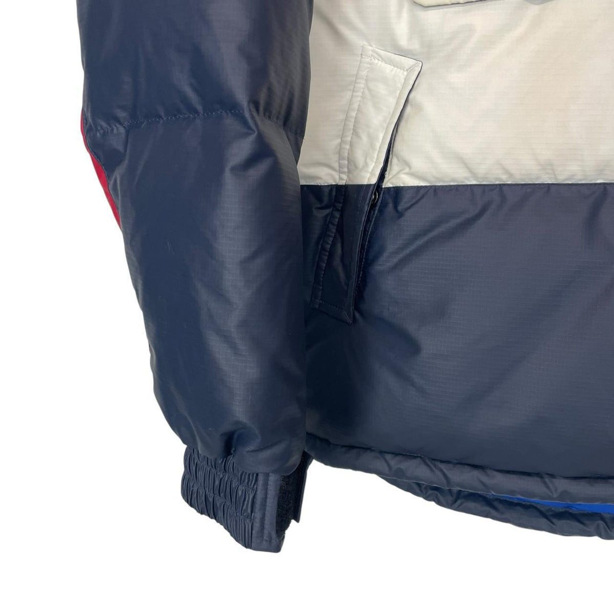 Tommy Hilfiger navy blue pullover jacket with 1/4 zip and hood, nylon material.