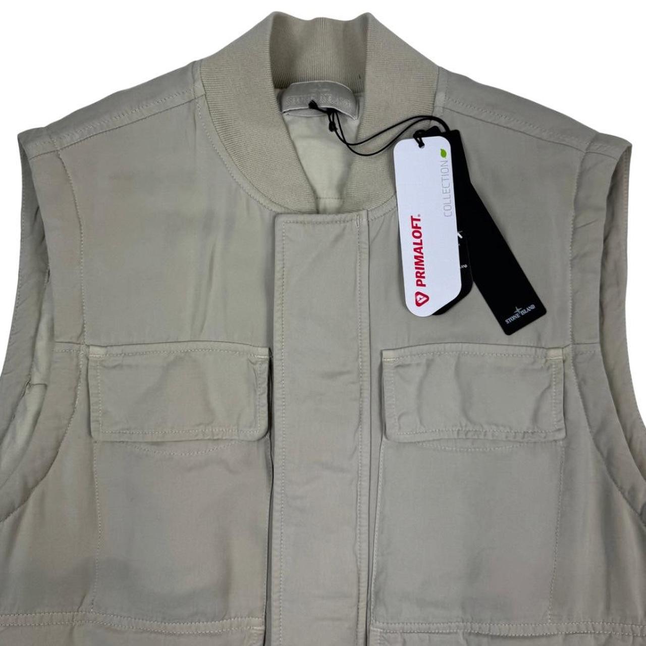 Stone Island beige vest jacket with logo patch and Primaloft material.