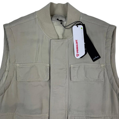 Stone Island beige vest jacket with logo patch and Primaloft material.