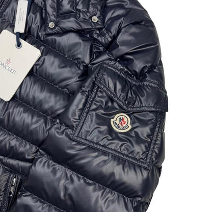 Moncler navy blue hooded puffer jacket with logo patch and nylon material.