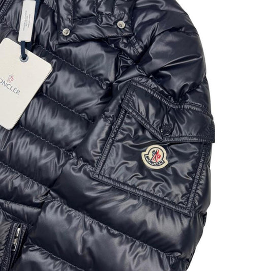 Moncler navy blue hooded puffer jacket with logo patch and nylon material.