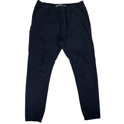 Stone Island navy blue joggers with logo patch and nylon material.