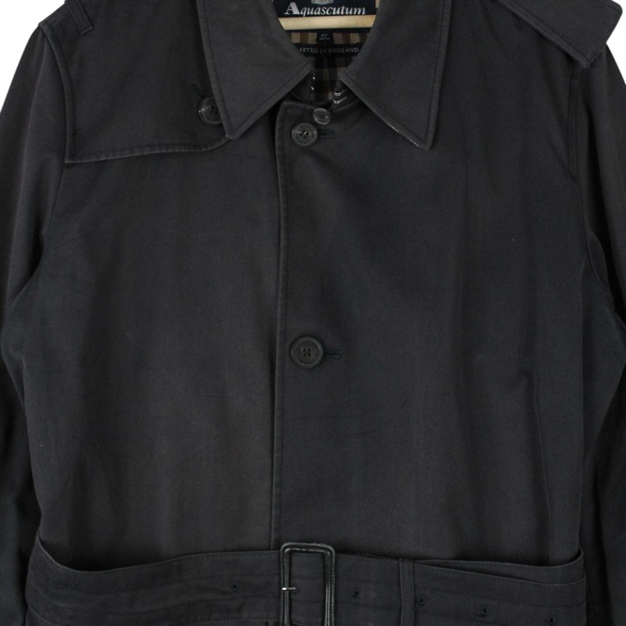 Aquascutum black trench coat with house check pattern and belted waist detail.