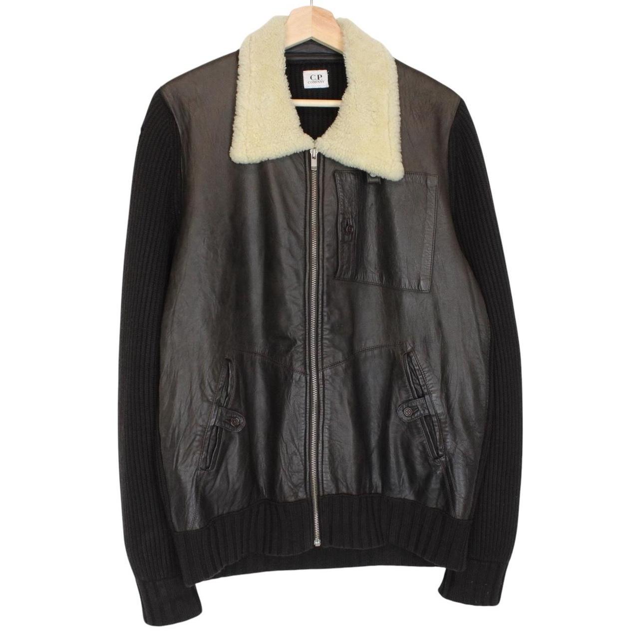 CP Company brown leather and wool shearling jacket with vintage design and logo details.