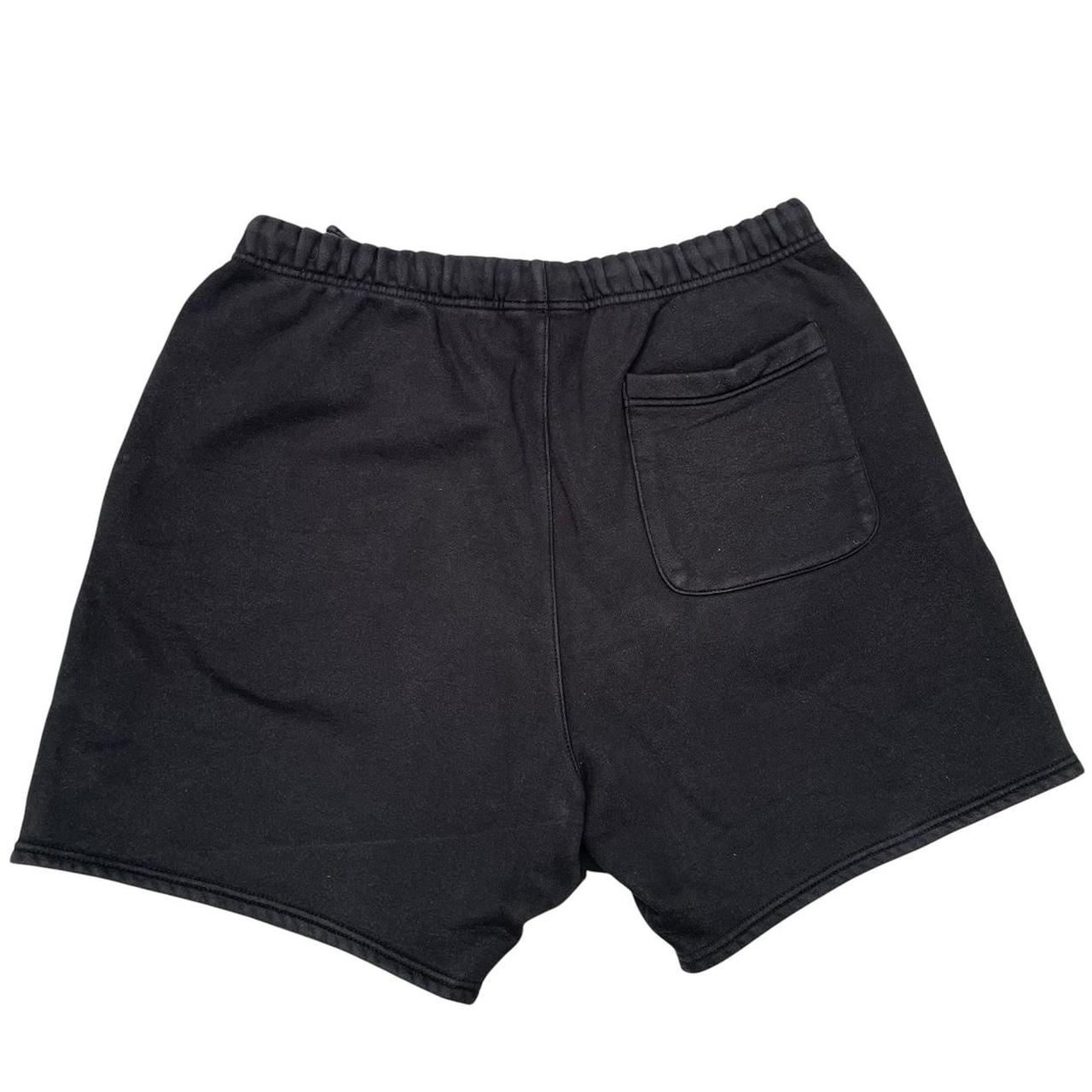Essentials black jogger shorts cotton material with faded detailing and logo.