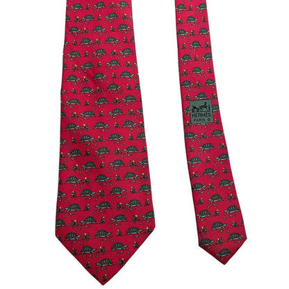 Hermes green and red silk tie featuring turtle print design and logo.