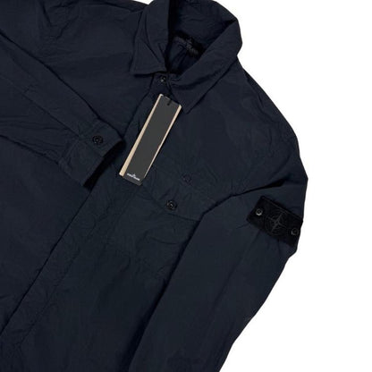 Stone Island black nylon overshirt jacket with ghost logo and smooth texture.