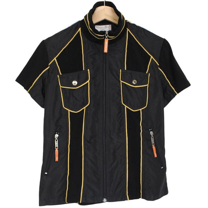 Christian Dior black and yellow jacket with 'Remove Before Flight' graphic detail.