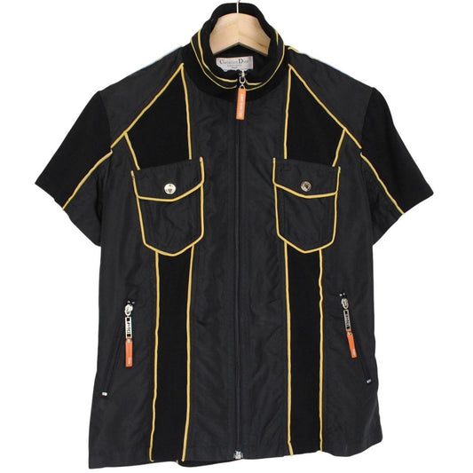 Christian Dior black and yellow jacket with 'Remove Before Flight' graphic detail.