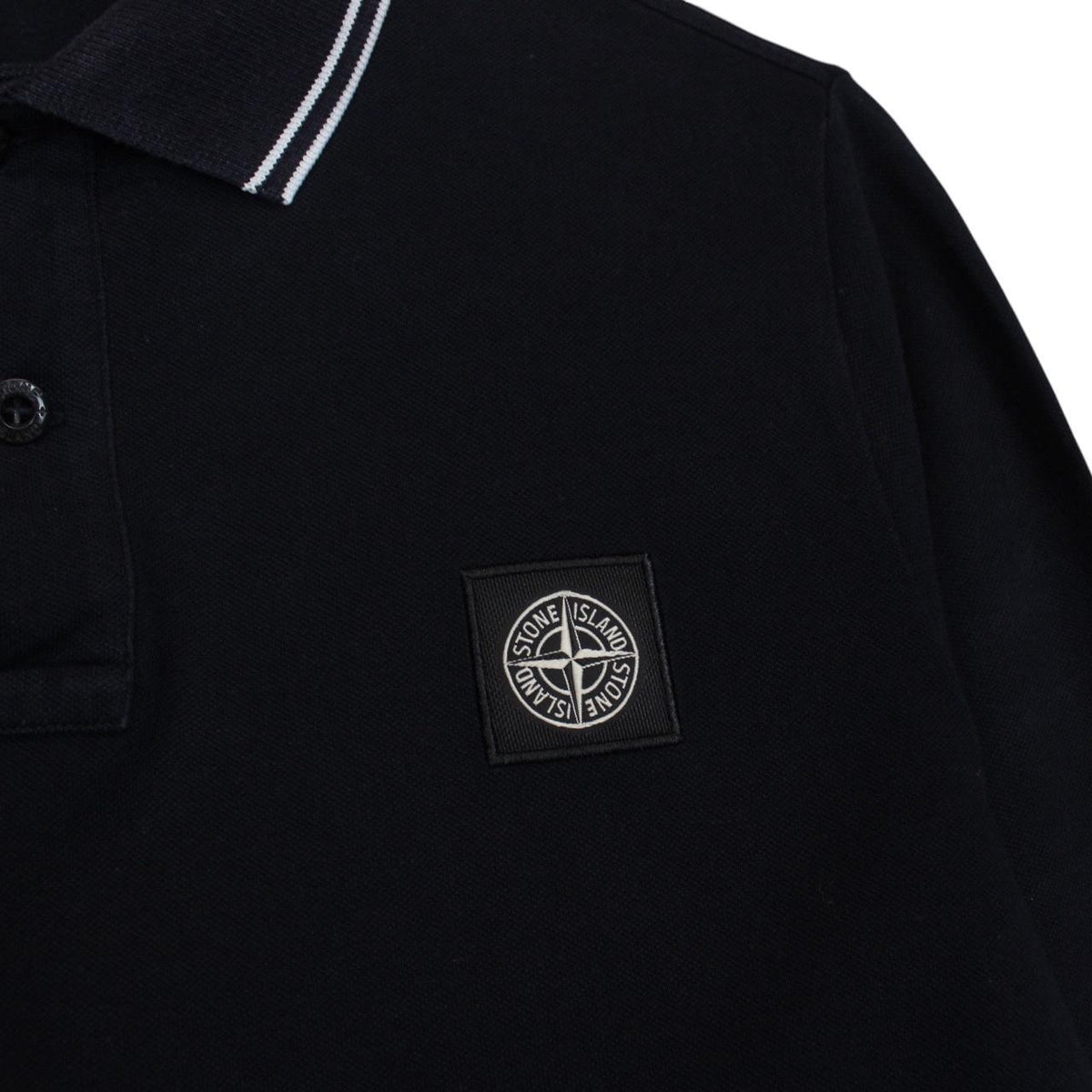 Stone Island black long sleeve polo shirt with embroidered compass logo, slim fit.