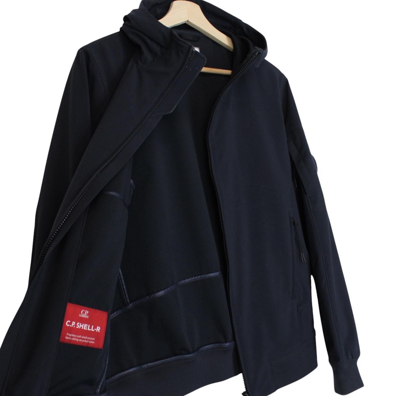 CP Company navy blue goggle jacket with full zip and soft shell material.