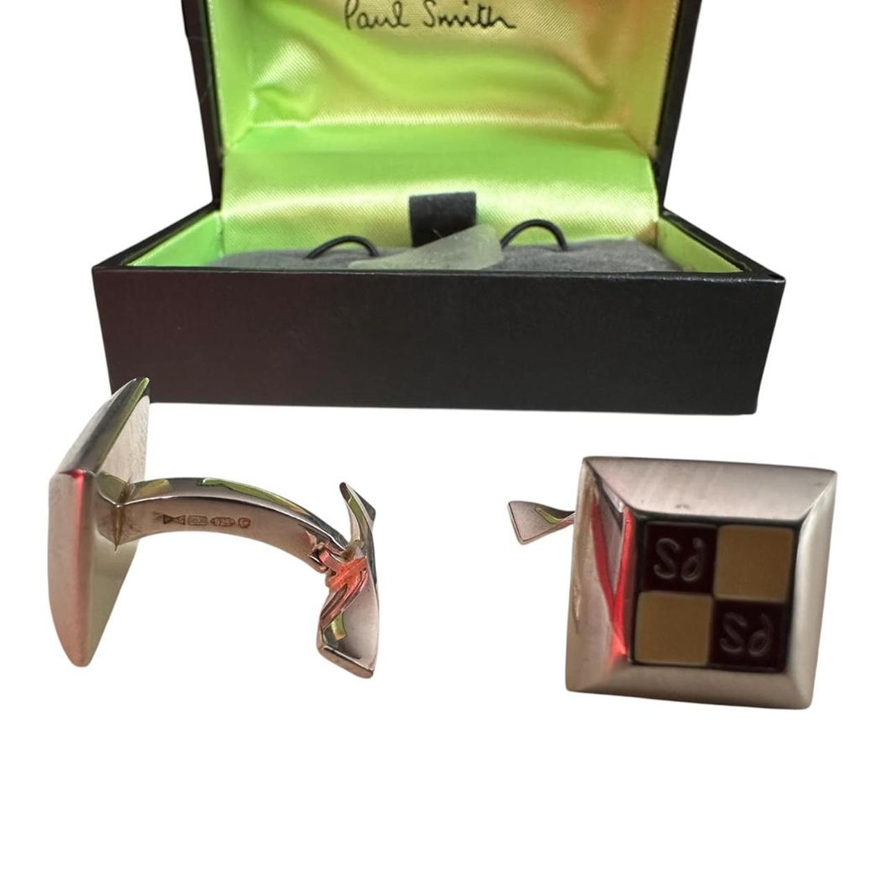 Paul Smith silver cufflinks with beveled edge and engraved "PS" logo.
