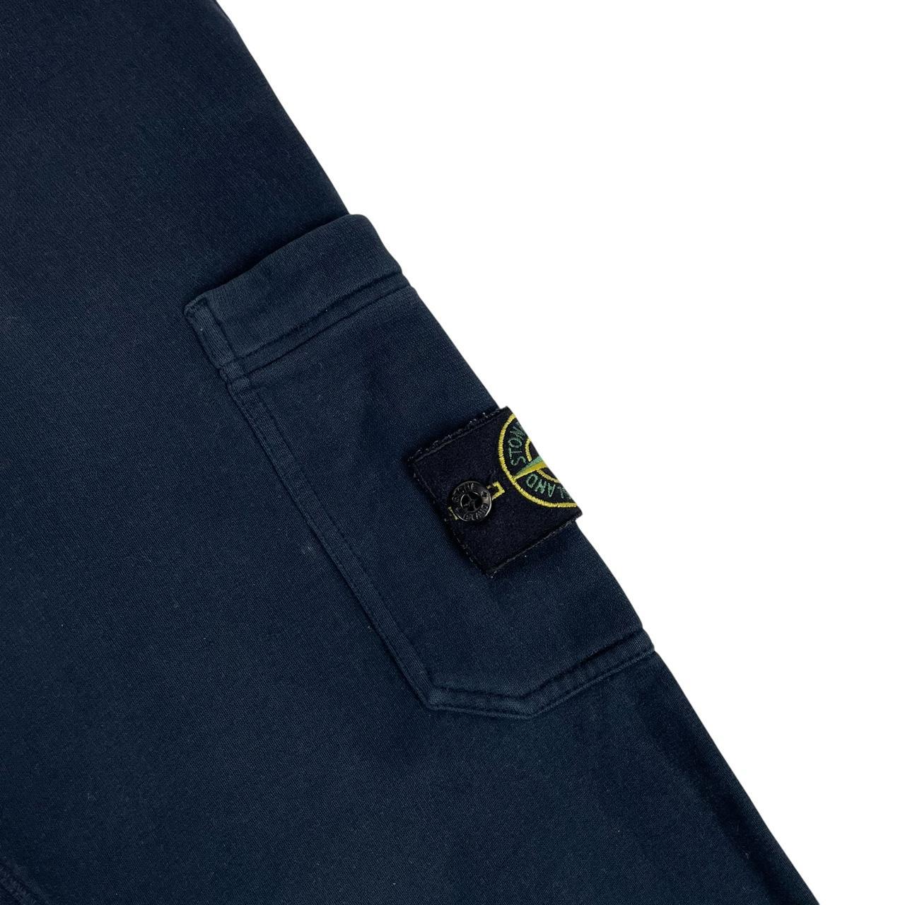 Stone Island navy blue joggers with logo patch and cotton material.
